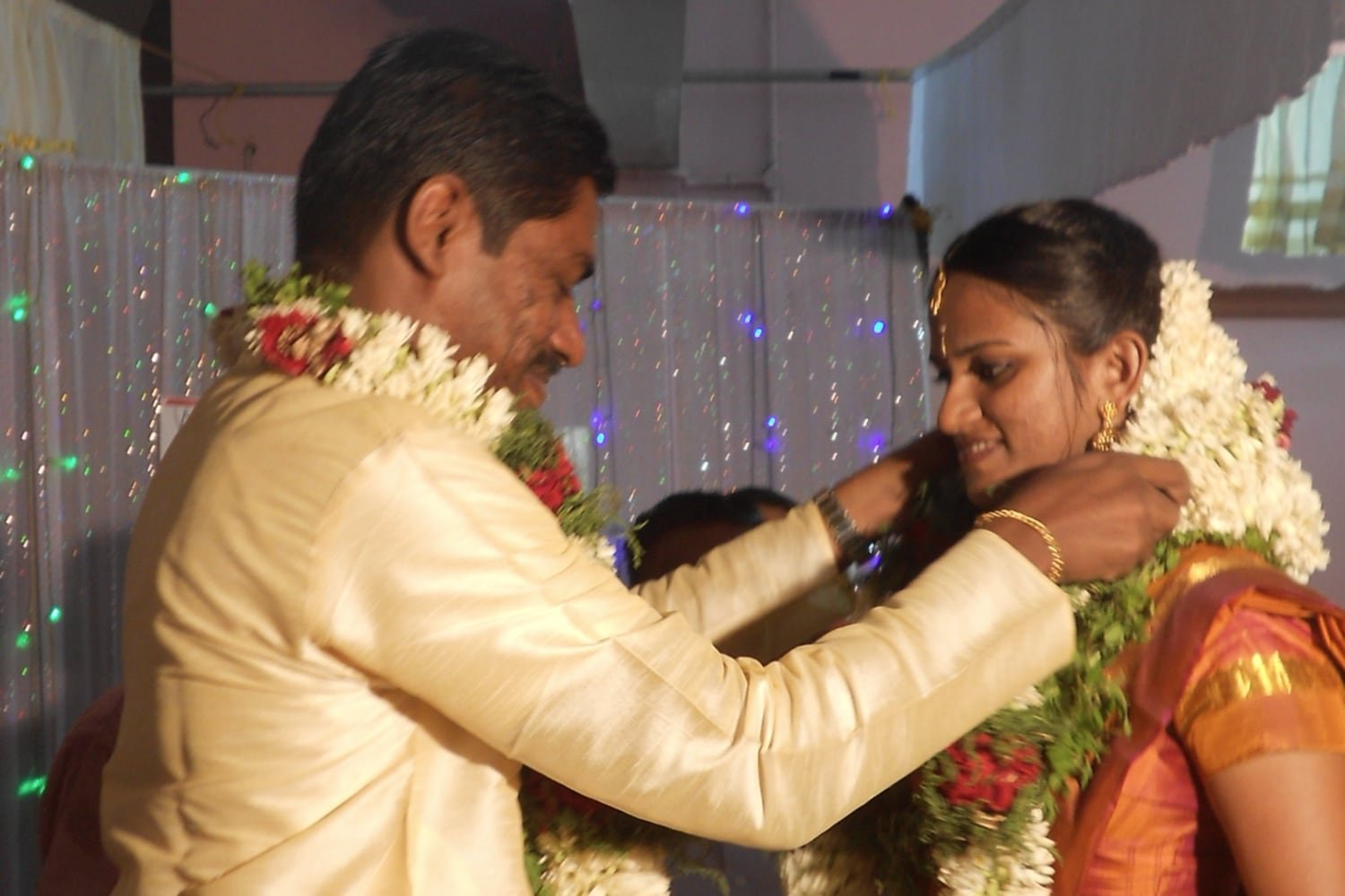 The bride and groom exchanging garlands during the ceremony